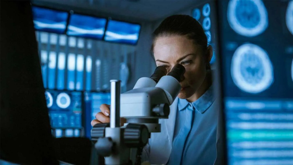 medical student working on microscope