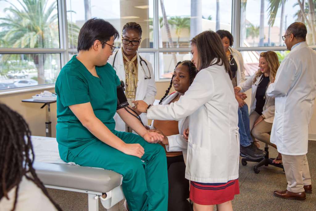 SMU Med Faculty member assist students in clinical skills small group breakouts