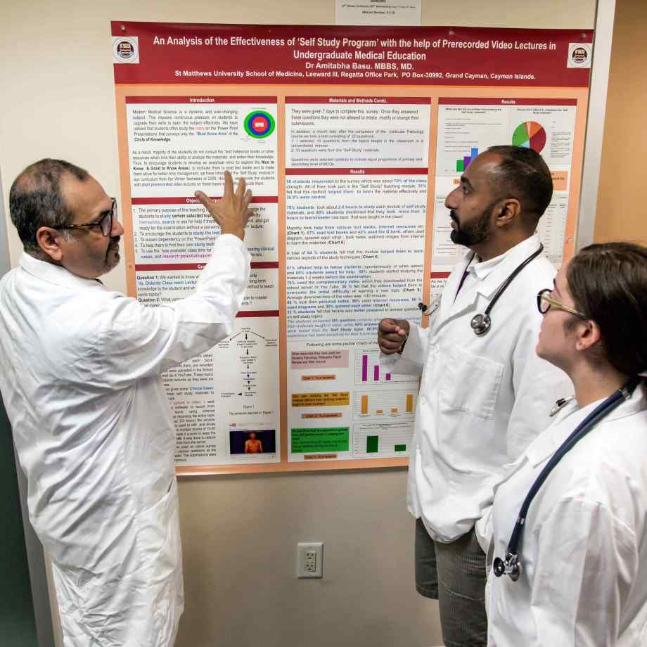 Dr. Basu, Dean of SMU Medical School provides feedback to students on their research project