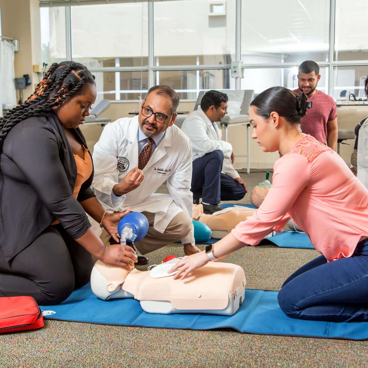 SMU Dean, Dr. Basu, provides passionate feedback to students during CPR lesson