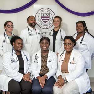 St. Matthew's University School of Medicine students pose for picture in their white coats