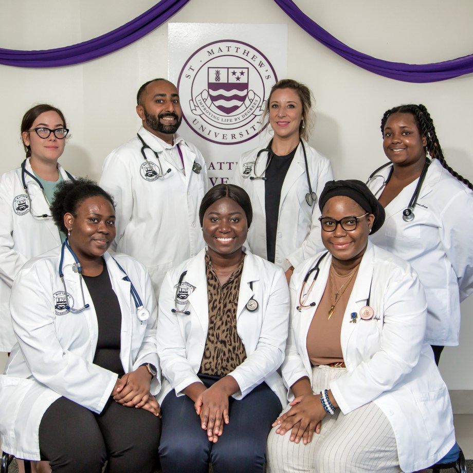 St. Matthew's University School of Medicine students pose for picture in their white coats
