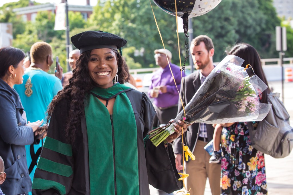 New SMU graduate celebrating during commencement