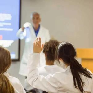 medical student raising hand in class