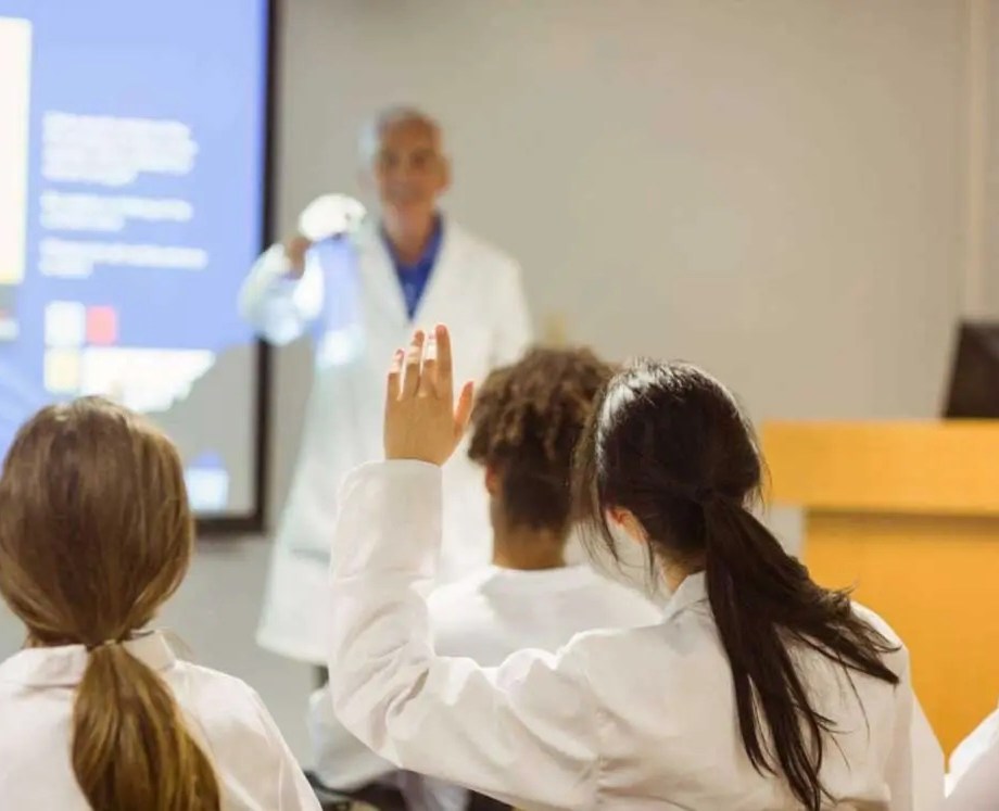 medical student raising hand in class